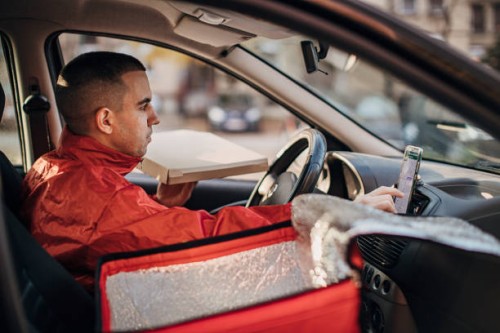 pizza delivery man using smart phone in a car - food stock pictures, royalty-free photos & images