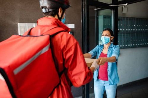 pizza delivery person deliver pizza to a customer - junk food stock pictures, royalty-free photos & images