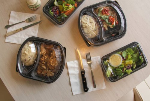 plastic containers of food at kitchen table - junk food stock pictures, royalty-free photos & images