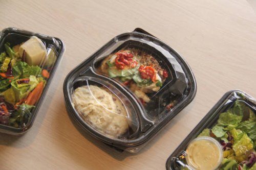 plastic containers of prepared food at kitchen table - junk food stock pictures, royalty-free photos & images