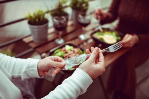 plastic cuttlery for takeaway salad eating by modern couple - junk food stock pictures, royalty-free photos & images