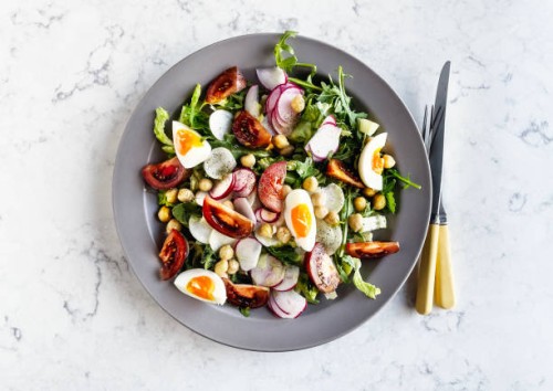 plate of fresh salad with boiled eggs on white background - food stock pictures, royalty-free photos & images