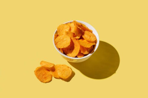 plate of potato chips on yellow background. flat lay, top view, copy space - junk food stock pictures, royalty-free photos & images