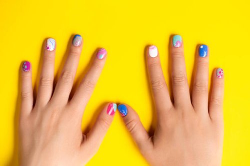 playful abstract art summer manicure in blue and purple colors on bright yellow background - nails art stock pictures, royalty-free photos & images