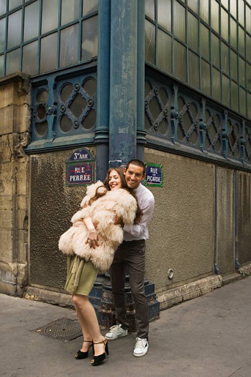 playful couple embracing on street corner - fashion stock pictures, royalty-free photos & images
