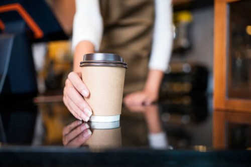 please enjoy drinking a coffee. the unrecognizable waitress serving coffee to a customer in a cafe. serving food and drink, point of sale system. - coffee stockfoto's en -beelden