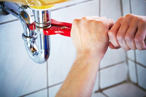 plumber hands holding wrench and fixing a sink in bathroom - home decoration stock pictures, royalty-free photos & images