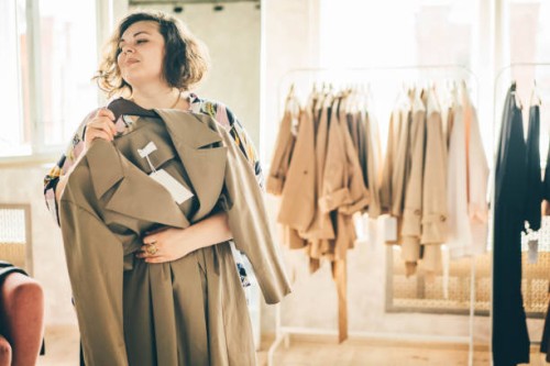 plus size woman choose fashioned dress in store. plus size women shopping. - fashion stock pictures, royalty-free photos & images