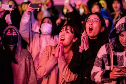 Pop fans react during a K-pop concert as part of the Seoul Festa 2023, at the Jamsil stadium in Seoul, on April 30, 2023.