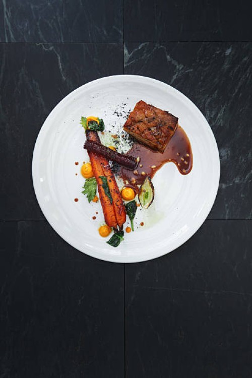 pork belly and vegetables with demi-glace sauce - food stockfoto's en -beelden
