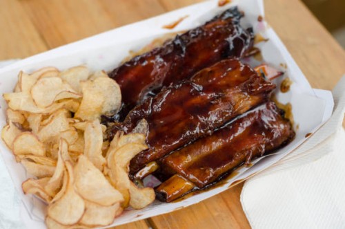 pork ribs with barbecue sauce and potato chips served on a food truck - junk food stock pictures, royalty-free photos & images
