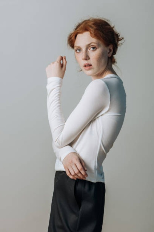 portrait of a beautiful red-haired girl look at the camera on a gray background studio shot. - fashion stock pictures, royalty-free photos & images