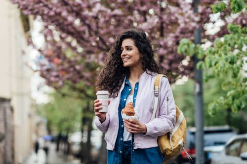 portrait of a beautiful woman having a coffee and breakfast on the street - junk food stock pictures, royalty-free photos & images