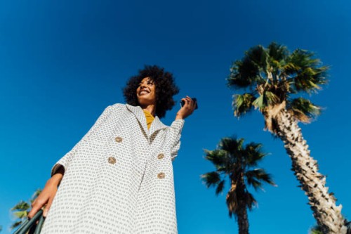 portrait of a beautiful woman, holding smartphone - fashion stock pictures, royalty-free photos & images