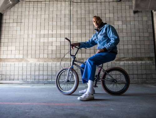 portrait of a bmx rider in warehouse environment - fashion stock pictures, royalty-free photos & images