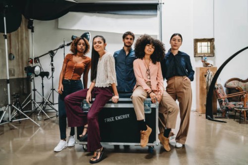 portrait of a creative group of people in a modern loft with photographic equipment in the background - fashion stock pictures, royalty-free photos & images