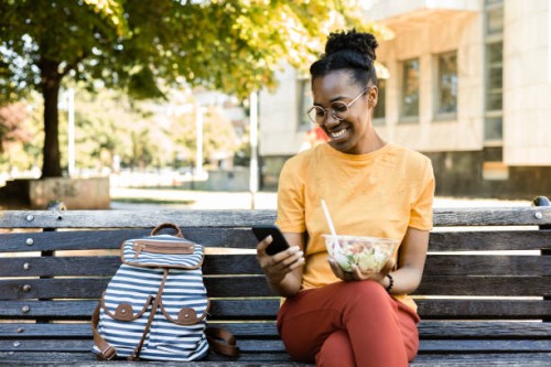 portrait of a happy afro young woman ready to eat her salad to go - junk food stock pictures, royalty-free photos & images