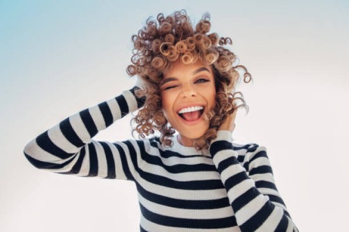 portrait of a happy girl against blue sky - fashion stock pictures, royalty-free photos & images