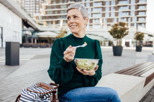portrait of a happy woman on a lunch break - junk food stock pictures, royalty-free photos & images