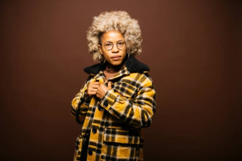 portrait of a latin woman against a brown background - fashion stock pictures, royalty-free photos & images