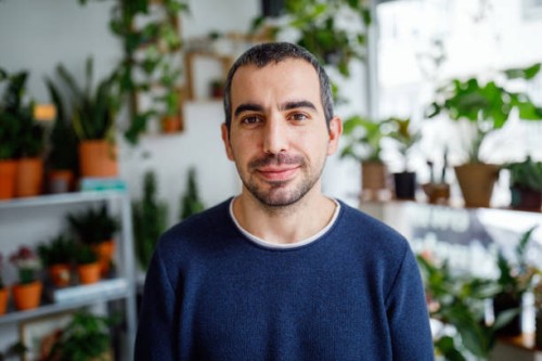 portrait of a man in flower shop - garden decoration stock pictures, royalty-free photos & images