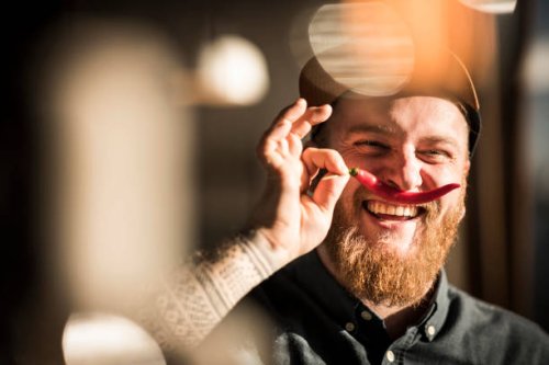 portrait of a man with a red chili moustache - food stock pictures, royalty-free photos & images