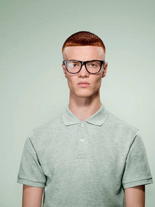 portrait of a red hair male with glasses on - fashion fotografías e imágenes de stock