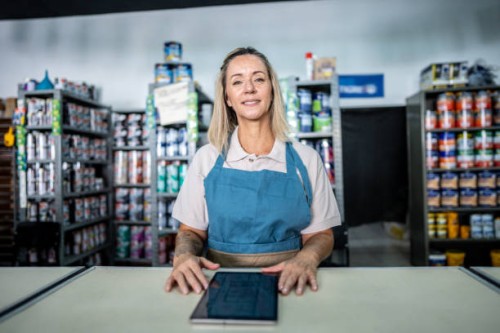 portrait of a saleswoman using the digital tablet at a paint store - home decoration stock pictures, royalty-free photos & images