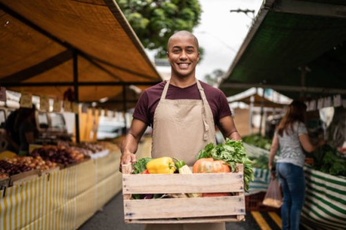 portrait of a seller at a street market - food stockfoto's en -beelden