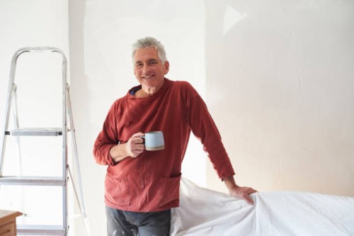 portrait of a senior man who is decorating his bedroom - home decoration stock pictures, royalty-free photos & images