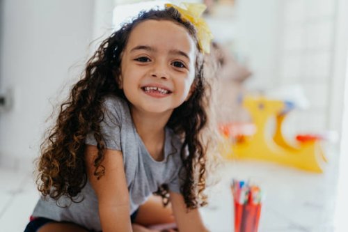portrait of a smiling little girl at home - hairstyle stock pictures, royalty-free photos & images