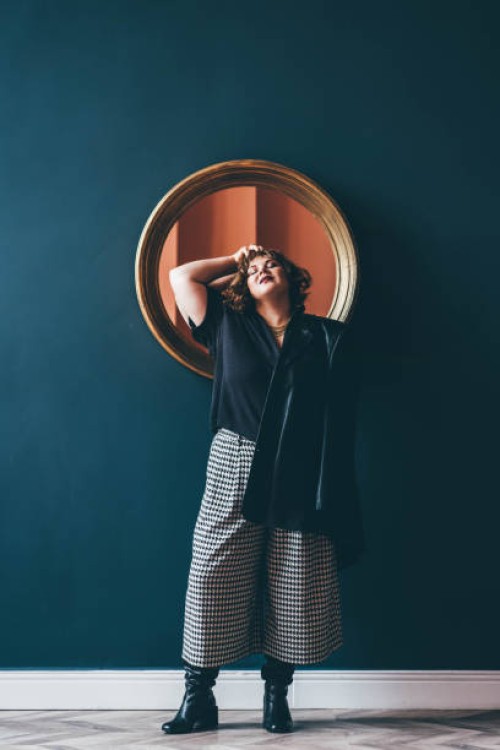 portrait of a smiling young plus size woman. - fashion stock pictures, royalty-free photos & images
