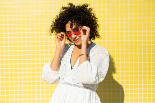 portrait of a woman against a yellow background - fashion stock-fotos und bilder