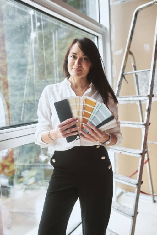 portrait of a woman designer with color palettes - home decoration stockfoto's en -beelden