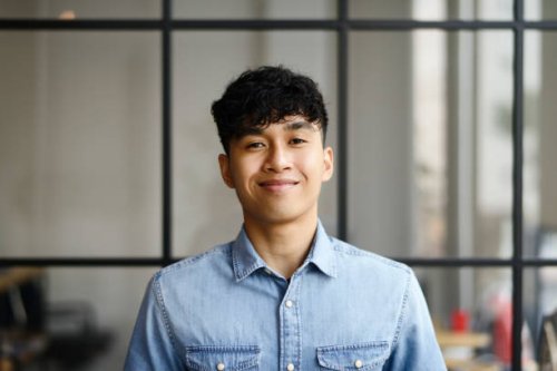 portrait of a young malay man in a modern office - hairstyle stock pictures, royalty-free photos & images