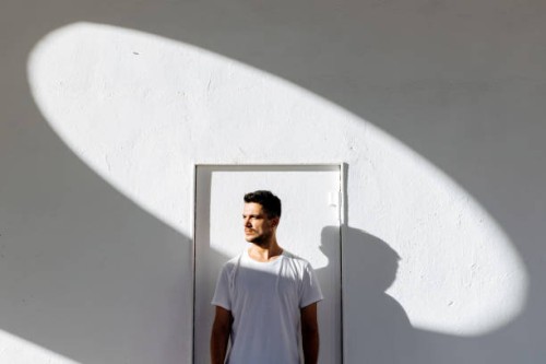 portrait of a young man in white t-shirt against white background - fashion stock pictures, royalty-free photos & images