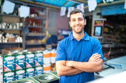 portrait of a young sales man standing in a paint store - home decoration stock pictures, royalty-free photos & images