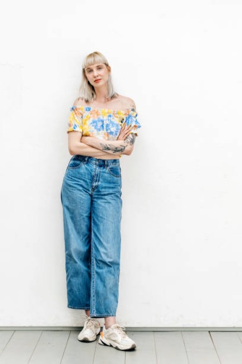 portrait of blond woman in high waisted jeans - fashion photos et images de collection