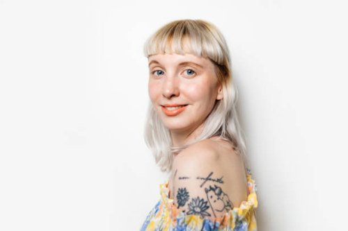 portrait of blond woman with shoulder tattoo - hairstyle stock pictures, royalty-free photos & images