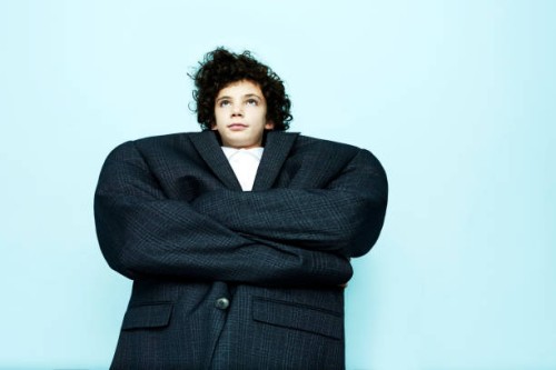 portrait of boy wearing big coat - fashion stock pictures, royalty-free photos & images