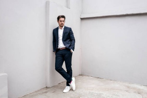 portrait of confident businessman leaning against a wall - fashion stock pictures, royalty-free photos & images