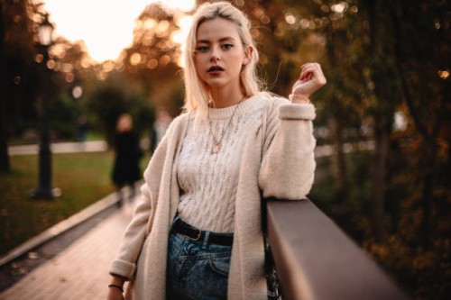 portrait of confident young woman standing in park during autumn - fashion stock pictures, royalty-free photos & images
