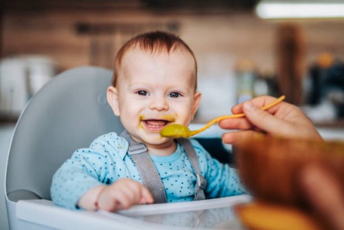 portrait of cute little baby boy eating his lunch. - food stock pictures, royalty-free photos & images