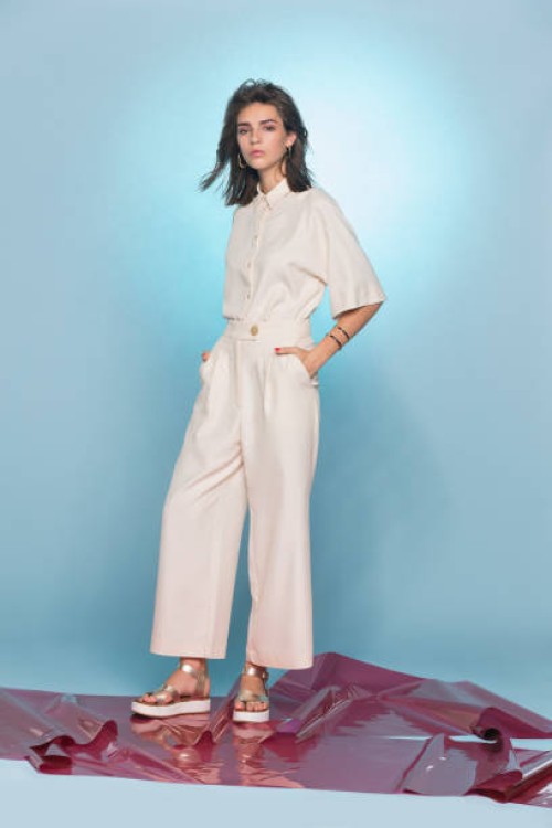 portrait of female fashion model posing against blue background - fashion stock pictures, royalty-free photos & images