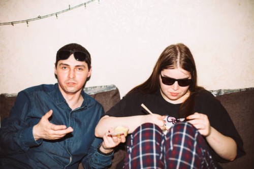 portrait of friends sitting on the sofa during house party - junk food stock pictures, royalty-free photos & images