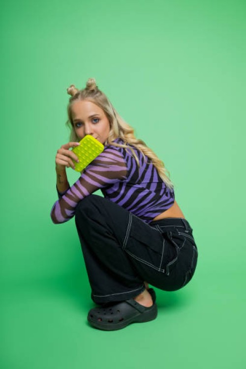 portrait of gen z young woman holding smart phone - fashion stock pictures, royalty-free photos & images