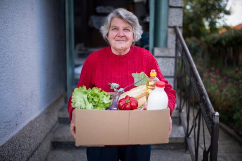portrait of happy senior woman with received crate with food during pandemic. - food stock pictures, royalty-free photos & images