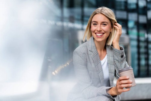 portrait of happy young businesswoman with takeaway coffee in the city - junk food stock pictures, royalty-free photos & images