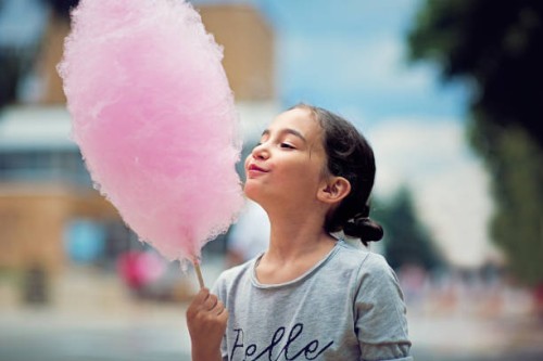 portrait of little girl eating cotton candy - food stock pictures, royalty-free photos & images