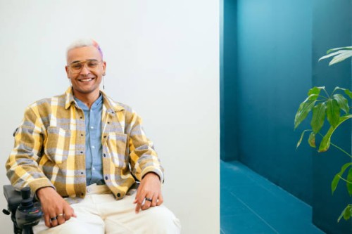 portrait of mixed race man with street style sit on wheelchair at white background - fashion stock pictures, royalty-free photos & images